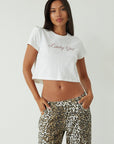 Graphic printed knit crop tee. Crewneck. Short sleeves. Unlined. white graphic tee. lucky girl t=graphic tee. summer top. basic top. basic tshirt. basic tee. cropped graphic tee