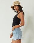 Relax fit mid-length denim shorts. Button fly. Five pocket construction. Raw hem. Unlined. denim shorts. light wash denim shorts. medium wash denim shorts