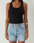 Relax fit mid-length denim shorts. Button fly. Five pocket construction. Raw hem. Unlined. denim shorts. light wash denim shorts. medium wash denim shorts