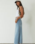 Denim maxi skirt. Button and zipper fly. Five pocket construction. Back slit. Raw hem. Unlined. blue denim maxi skirt. denim maxi skirt with back slit. summer outfit. casual outfit. cute casual outfit.