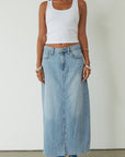 Denim maxi skirt. Button and zipper fly. Five pocket construction. Back slit. Raw hem. Unlined. blue denim maxi skirt. denim maxi skirt with back slit. summer outfit. casual outfit. cute casual outfit.