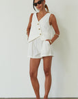 Woven cropped vest. Front button down closures. Faux front pockets. Fully lined. Woven shorts. Elastic waistband. Side pockets. Unlined. summer set outfit. summer outfit. vest and short set. white set.
