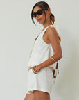 Woven cropped vest. Front button down closures. Faux front pockets. Fully lined. Woven shorts. Elastic waistband. Side pockets. Unlined. summer set outfit. summer outfit. vest and short set. white set.
