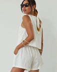 Woven cropped vest. Front button down closures. Faux front pockets. Fully lined. Woven shorts. Elastic waistband. Side pockets. Unlined. summer set outfit. summer outfit. vest and short set. white set.