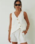 Woven cropped vest. Front button down closures. Faux front pockets. Fully lined. Woven shorts. Elastic waistband. Side pockets. Unlined. summer set outfit. summer outfit. vest and short set. white set.