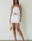 Woven crop top. Beaded halter neckline with adjustable tie closure. Front snap closure. Unlined. white cropped tank top. white halter top. asymmetrical top. summer top. vacation top. vacation outfit