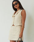 Woven sleeveless top. Front button down closure. Fully lined. Woven skirt. Hook and eye and zipper fly. Side pockets. Fully lined. summer set. cute casual outfit. summer outfit. skirt set. vest top set. tan skirt and vest set