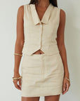 Woven sleeveless top. Front button down closure. Fully lined. Woven skirt. Hook and eye and zipper fly. Side pockets. Fully lined. summer set. cute casual outfit. summer outfit. skirt set. vest top set. tan skirt and vest set