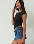 Denim skirt. Button and zipper fly. Five pocket construction. Raw edge hem. Unlined. mid wash denim skirt. dark wash denim skirt. denim mini skirt. summer skirt