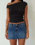 Denim skirt. Button and zipper fly. Five pocket construction. Raw edge hem. Unlined. mid wash denim skirt. dark wash denim skirt. denim mini skirt. summer skirt