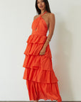 Crinkle woven tiered maxi dress. Adjustable halter tie neckline. Back hook and eye and zipper closures. Fully lined. orange maxi dress. wedding guest dress. evening dress. vacation dress. fancy dinner dress