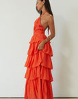 Crinkle woven tiered maxi dress. Adjustable halter tie neckline. Back hook and eye and zipper closures. Fully lined. orange maxi dress. wedding guest dress. evening dress. vacation dress. fancy dinner dress