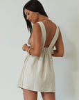Woven sleeveless dress. Fixed straps. Adjustable drawstring waist. Unlined. tan mini dress. cream mini dress. summer dress. dinner dress. evening dress. vacation dress. vacation outfit