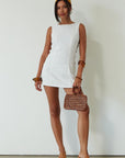 Woven sleeveless dress. Side ring details. Back zipper closure. Fully lined. white mini dress. high neck line mini dress. summer dress. engagement dress. bridal shower dress.
