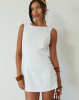 Woven sleeveless dress. Side ring details. Back zipper closure. Fully lined. white mini dress. high neck line mini dress. summer dress. engagement dress. bridal shower dress.