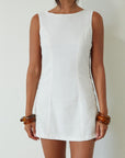 Woven sleeveless dress. Side ring details. Back zipper closure. Fully lined. white mini dress. high neck line mini dress. summer dress. engagement dress. bridal shower dress.