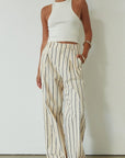 Striped woven pants. Hook and eye and zipper fly. Side pockets. Unlined. beige striped pant. work pant. casual work pant. vacation outfit. vacation pant.