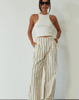 Striped woven pants. Hook and eye and zipper fly. Side pockets. Unlined. beige striped pant. work pant. casual work pant. vacation outfit. vacation pant.