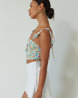 Floral printed woven crop top. Ruffle adjustable tie straps. Underwire cups. Front tie. Adjustable drawstring sides. Ruched bodice. Boning in bodice. Back hook and eye and exposed zipper closure. Fully lined. floral tank top. floral cropped tank. summer top. spring top