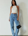 Denim relaxed fit jeans. Button and zipper fly. Five pocket construction. Unlined. mid wash denim jeans.