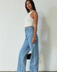 Denim relaxed fit jeans. Button and zipper fly. Five pocket construction. Unlined. mid wash denim jeans.