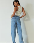 Denim relaxed fit jeans. Button and zipper fly. Five pocket construction. Unlined. mid wash denim jeans.