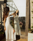 Woven maxi dress. Adjustable halter neckline with tie closure. Front slit. Back hook and eye and zipper closures. Fully lined. European summer. European summer dress. European summer aesthetic. Tuscany outfit inso. Tuscany aesthetic. Summer dress. white dress. white maxi dress. summer outfit. everyday dress. vacation dress. outfit to wear to tuscany. nice dinner dress. dinner dress. fancy dinner dress. white halter maxi dress. bride dress. engagement dress. engagement party dress