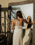 Woven maxi dress. Adjustable halter neckline with tie closure. Front slit. Back hook and eye and zipper closures. Fully lined. European summer. European summer dress. European summer aesthetic. Tuscany outfit inso. Tuscany aesthetic. Summer dress. white dress. white maxi dress. summer outfit. everyday dress. vacation dress. outfit to wear to tuscany. nice dinner dress. dinner dress. fancy dinner dress. white halter maxi dress. bride dress. engagement dress. engagement party dress