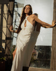 Woven maxi dress. Adjustable halter neckline with tie closure. Front slit. Back hook and eye and zipper closures. Fully lined. European summer. European summer dress. European summer aesthetic. Tuscany outfit inso. Tuscany aesthetic. Summer dress. white dress. white maxi dress. summer outfit. everyday dress. vacation dress. outfit to wear to tuscany. nice dinner dress. dinner dress. fancy dinner dress. white halter maxi dress. bride dress. engagement dress. engagement party dress