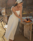 Sleeveless maxi dress. Elastic smocked bodice. Gauze skirt. Adjustable toe straps. Side pockets. Partially lined. European summer aesthetic. Tuscany outfit inso. Tuscany aesthetic. Summer dress. white maxi dress. summer outfit. everyday dress. vacation dress. outfit to wear to tuscany. day dress. white ruffled maxi dress. shoulder tie strap dress