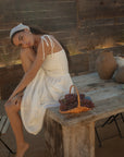 Sleeveless maxi dress. Elastic smocked bodice. Gauze skirt. Adjustable toe straps. Side pockets. Partially lined. European summer aesthetic. Tuscany outfit inso. Tuscany aesthetic. Summer dress. white maxi dress. summer outfit. everyday dress. vacation dress. outfit to wear to tuscany. day dress. white ruffled maxi dress. shoulder tie strap dress