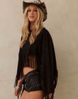 black Faux suede long sleeve top
Fringe hem
Adjustable sleeve tie
Unlined