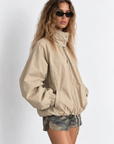 beige Oversized jacket features a slouchy silhouette, a lightweight cotton-blend fabrication, and a timeless funnel-neck collar for added dimension
Raglan sleeves
Front zipper closure
Side slit pockets