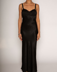 Textured black satin maxi dress. Adjustable elastic straps. Back hook and eye and zipper closures. Partially lined. black wedding guest dress