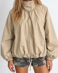 beige Oversized jacket features a slouchy silhouette, a lightweight cotton-blend fabrication, and a timeless funnel-neck collar for added dimension
Raglan sleeves
Front zipper closure
Side slit pockets