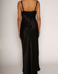 Textured black satin maxi dress. Adjustable elastic straps. Back hook and eye and zipper closures. Partially lined. black wedding guest dress
