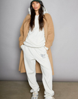 Graphic printed knit sweatset. Elastic waistband and leg openings. Side pockets. Fleece lining. hooded sweater. sweatpant. grey sweatset. out of office sweat set