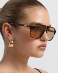 Modern aviator-inspired frame
Featuring a bold flat-top silhouette with geometric shaping
Navigator-inspired angular shaping
Oversized lens profile for full coverage
Polarisation: Category 3
UV Protection: UV400
Double bridge design
Keyhole cut-out detail between bridges
Slim arm design
Lens Height: 5.16cm / Temple Length: 14.5cm / Temple Tip Width: 10.5cm /
Nose Bridge: 1.8cm, Frame Width: 14.4cm