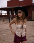 Embroidered knit corset
Adjustable halter tie neck
Front lace up closure
Back hook and eye and zipper closures
Fully lined
Studded details
Coachella outfit
Stagecoach outfit
Festival Outfit