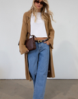 Fuzzy heather knit longline cardigan. Collar neckline. Long sleeves. Front pockets. Open front. Unlined. fall cardigan. tan long cardigan