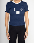 Graphic printed elastic smocked crop top. V-neckline. Short sleeves. Contrast detailing. navy tee. lioness scrunched graphic tee