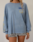 blue Graphic printed acid wash knit top. Crewneck. Long sleeves. Unlined.