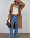 Fuzzy heather knit longline cardigan. Collar neckline. Long sleeves. Front pockets. Open front. Unlined. fall cardigan. tan long cardigan