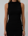 Sleeveless knit dress. Mock neck. Ruched sides. Fully lined. black mini dress. black mock neck mini dress. fall dress. fall outfit