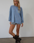 blue Graphic printed acid wash knit top. Crewneck. Long sleeves. Unlined.