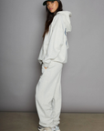 Graphic printed knit sweatset. Elastic waistband and leg openings. Side pockets. Fleece lining. hooded sweater. sweatpant. grey sweatset. out of office sweat set
