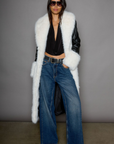 Faux leather longline coat. Faux fur trim. Collar neckline. Long sleeves. Open front. Tie waist. Fully lined. black leather coat. fur coat. coat for winter. cute leather coat. fashionable leather coat