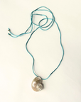 Turbo shell silk cord necklace
Polished and hand-drilled
Silk cord with gold plated beads
Can be worn multiple ways
Length: 26"
Turbo shell approx. 1.5"
Size color and shape of shell may vary slightly