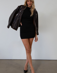 Sleeveless knit dress. Mock neck. Ruched sides. Fully lined. black mini dress. black mock neck mini dress. fall dress. fall outfit