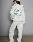 Graphic printed knit sweatset. Elastic waistband and leg openings. Side pockets. Fleece lining. hooded sweater. sweatpant. grey sweatset. out of office sweat set